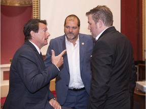Quebec Opposition Leader Pierre-Karl Péladeau, left, chats with Opposition party caucus members Pascal Bérubé, right and Harold LeBel, centre, at the beginning of caucus meeting, Wednesday, September 9, 2015, at the legislature in Quebec City.