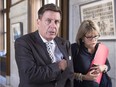 Quebec Municipal Affairs Minister Pierre Moreau walks to a cabinet meeting with press attache Catherine Poulin, Wednesday, Sept. 23, 2015 at the legislature in Quebec City.