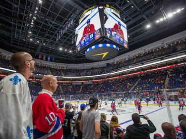 Hockey fans watch the warmup before the preseason NHL match between the Montreal Canadiens and the Pittsburgh Penguins at the Centre Vidéotron in Quebec City on Monday, Sept. 28, 2015.