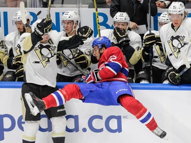 Montreal Canadiens right wing Brian Flynn and Pittsburgh Penguins right wing Pascal Dupuis collide during the first period of their preseason NHL match at the Centre Vidéotron in Quebec City on Monday, Sept. 28, 2015.