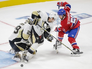 Montreal Canadiens centre David Desharnais attempts to recover a rebound against Pittsburgh Penguins defenceman David Warsofsky, centre, and goalie Marc-Andre Fleury, left, during the first period of their preseason NHL match at the Centre Vidéotron Centre in Quebec City on Monday, Sept. 28, 2015.