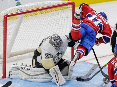 Montreal Canadiens right wing Brendan Gallaghe trips as he attempts a shot against Pittsburgh Penguins goalie Marc-Andre Fleury during the third period of their preseason NHL match at the Centre Vidéotron in Quebec City on Monday, Sept. 28, 2015.