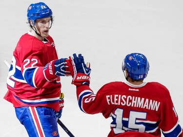 Right wing Dale Weise, left, is congratulated by Montreal Canadiens left wing Tomas Fleischmann after scoring on an empty net during the third period of their preseason NHL match at the Centre Vidéotron  in Quebec City on Monday, Sept. 28, 2015.