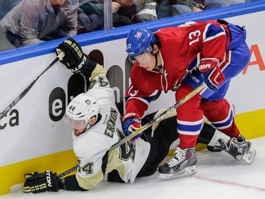 Pittsburgh Penguins defenceman Tim Erixon falls after colliding with Montreal Canadiens right wing Alexander Semin during the first period of their preseason NHL match at the Centre Vidéotron in Quebec City on Monday, Sept. 28, 2015.