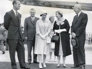 Engaged in jovial conversation at the RCAF base, St. Hubert, are Prince Philip, Prime Minister Diefenbaker, the Queen (Queen Elizabeth II), Mrs. Diefenbaker, Mrs. Eisenhower and President Eisenhower.  The President and his wife had just arrived on the Columbine from Washington for the St. Lawrence Seaway opening.  June 26, 1959.