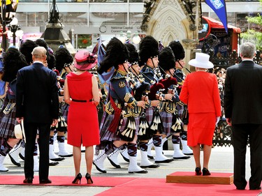 Queen Elizabeth II (2nd from R) stands next to Canadian Prime Minister Stephen Harper (R), as Prince Philip, Duke of Edinburgh (L) stands with Mrs. Laureen Harper (2nd from L), during a march by the Guard of Honour outside the Canadian Parliament on July 1, 2010 in Ottawa, Canada.