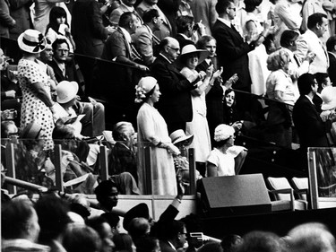 Queen Elizabeth II at the 1976 Olympic Games opening ceremony in Montreal. Standing beside her is Mayor Jean Drapeau and his wife.