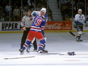 Todd Ewen #36 of the Mighty Ducks of Anaheim and Nick Kypreos #19 of the New York Rangers exchange blows during a game at The Arrowhead Pond of Anaheim on January 28, 1994 in Anaheim, California.