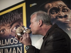 Professor Lee Berger kisses the skull of a Homo Naledi , a newly discovered human ancestor during the unveiling of the discovery Sept. 10, 2015 in Maropeng