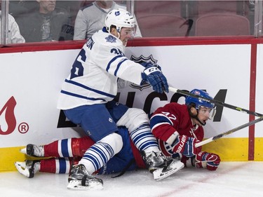 Toronto Maple Leafs' Scott Harrington, left, falls on Montreal Canadiens' Sven Andrighetto during first period NHL pre-season hockey action Tuesday, September 22, 2015, in Montreal.