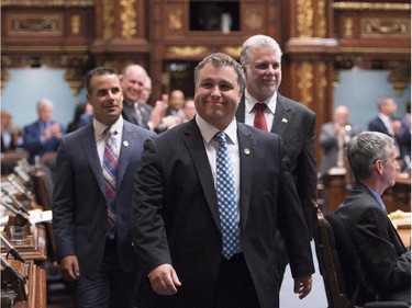 Government MNA Sebastien Proulx is escorted by Quebec Premier Philippe Couillard and party whip Stephane Billette during as the legislature resumes for its fall session, Tuesday, September 15, 2015 at the legislature in Quebec City. Proulx was elected in a June 17 byelection.