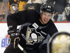 Pittsburgh Penguins' Sidney Crosby looks to shoot on goalie Marc-Andre Fleury during training camp on Sept. 18, 2015, in Cranberry Township, Pa.