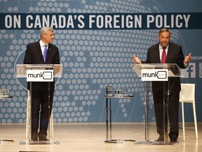 Conservative Leader Stephen Harper, left, and NDP Leader Tom Mulcair participate in the Munk Debate on Canada's foreign policy in Toronto, on Monday, Sept. 28, 2015.