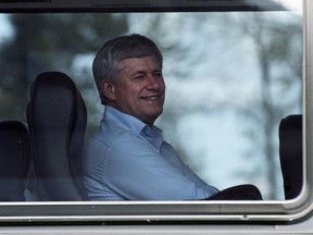 Conservative Leader Stephen Harper smiles as he looks out the window of his bus Tuesday, September 15, 2015  in Abbotsford, B.C.