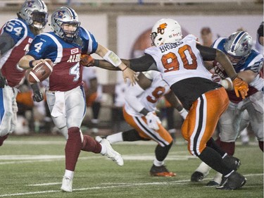 Montreal Alouettes' quarterback Tanner Marsh, left, is tackled by B.C. Lions' Jabar Westerman during second half CFL football action in Montreal on Thursday, September 3, 2015.