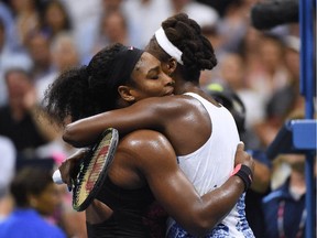 Serena Williams (L) of the U.S. hugs her sister Venus after Serena won their 2015 U.S. Open quarterfinals women's singles match at the USTA Billie Jean King National Tennis Center on September 8, 2015 in New York.