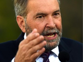 NDP leader Tom Mulcair answers media questions after delivering a statement in Edmonton on Friday, September 11, 2015.