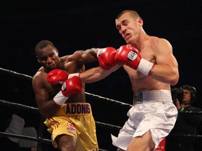 Adonis Stevenson, left, fights Tommy Karpency during their WBC light-heavyweight boxing match, Friday, Sept. 11, 2015, in Toronto. Stevenson defended his title.