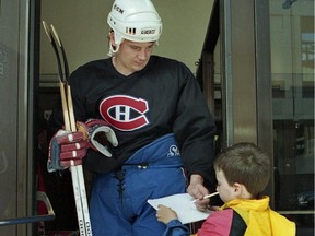 The Canadiens' Todd Ewen signs an autograph for a fan at the Forum in Montreal on May 27, 1993.
