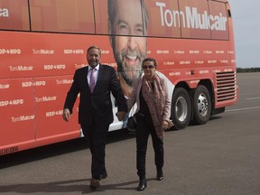 NDP Leader Tom Mulcair and his wife Catherine Pinhas head to the plane after a campaign stop  in Moncton, N.B.