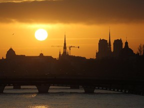 The sun rises over the River Seine, the Sainte Chapelle and Notre-Dame cathedral on Feb. 9, 2015 in Paris.