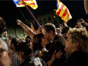 A couple kisses after the partial results of the regional election in Barcelona on September 27, 2015. Separatists in Catalonia claimed victory today in a regional election that they have vowed will lead to them declaring the region independent from Spain.