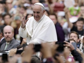 Pope Francis acknowledges faithful as he parades on his way to celebrate Mass on September 27, 2015, in Philadelphia.