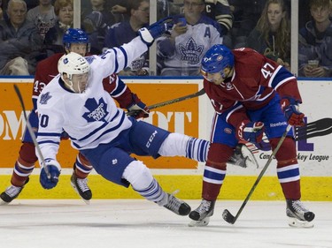 Toronto Maple Leafs forward Frederik Gauthier is checked by Montreal Canadiens forward Jeremy Gregoire during their NHL Rookie Tournament hockey game at Budweiser Gardens in London, Ont., on Saturday, September 12, 2015.