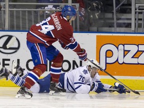 Canadiens centre Michael McCarron battles for puck with Maple Leafs' Frederik Gauthier during NHL Rookie Tournament game at Budweiser Gardens in London, Ont., on Sept. 12, 2015.