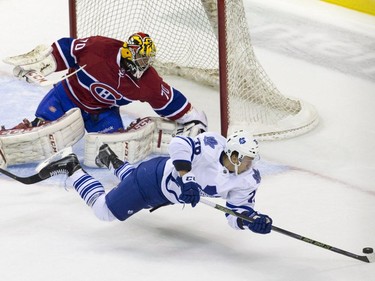 Toronto Maple Leafs forward Nikolai Skladnichenko flies through the air as he tries to shoot a rebounded puck on Montreal Canadiens goaltender Michael McNiven during their NHL Rookie Tournament hockey game at Budweiser Gardens in London, Ont., on Saturday, September 12, 2015.