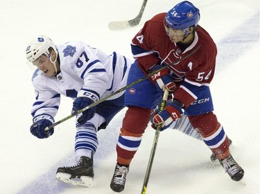 Toronto Maple Leafs forward Scott Eansor loses his footing as he gets tied up with Montreal Canadiens forward Charles Hudon during their NHL Rookie Tournament hockey game at Budweiser Gardens in London, Ont., on Saturday, September 12, 2015.