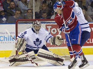Toronto Maple Leafs goaltender Justin Nichols watches an incoming puck as Montreal Canadiens forward Sam Studnicka moves to allow it through during their NHL Rookie Tournament hockey game at Budweiser Gardens in London, Ont. on Saturday, September 12, 2015.