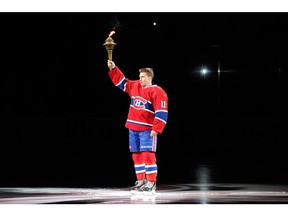 The Canadiens' Brendan Gallagher holds torch before game against the Toronto Maple Leafs after being introduced to fans during pre-game ceremonies at the Bell Centre on Oct. 1, 2013.