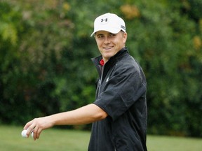 Jordan Spieth of the United States smiles as he walks across the practice green during the third round of the TOUR Championship By Coca-Cola at East Lake Golf Club on Sept. 26, 2015, in Atlanta.