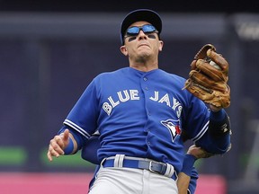 Toronto Blue Jays shortstop Troy Tulowitzki  reacts as he collides with Blue Jays centre fielder Kevin Pillar fielding a second-inning fly ball in a baseball game against the New York Yankees at Yankee Stadium in New York, Saturday, Sept. 12, 2015.