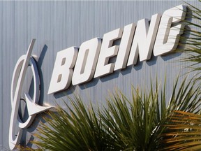 (FILES) The Boeing logo is seen at Boeing's new production facilities in this April 27, 2012, file photo in North Charlston, South Carolina. The Lockheed Martin logo the 46th International Paris Air in this June 16, 2005, file photo at Le Bourget Airport. Boeing and Lockheed Martin said on October 25, 2013 they have teamed up to bid for a new US Air Force bomber program. Boeing is acting as the prime contractor, and Lockheed is the main teammate in the bid for the Long-Range Strike Bomber program, the companies said in a joint statement. "Boeing and Lockheed Martin are bringing together the best of the two enterprises, and the rest of industry, in support of the Long-Range Strike Bomber program, and we are honored to support our US Air Force customer and this important national priority," said Dennis Muilenburg, president and chief executive of Boeing Defense, Space & Security.  FILES/AFP PHOTO/PAUL J. RICHARDS (Top)/PIERRE VERDYSTF/AFP/Getty Images