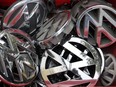 Volkswagen ornaments sit in a box in a scrap yard in Berlin, Germany, Wednesday, Sept. 23, 2015. The revelation that Volkswagen rigged diesel-powered cars to emit lower emissions during EPA tests is particularly stunning since Volkswagen has long projected a quirky brand image with an emphasis on being environmentally friendly _ an image that now appears in tatters.