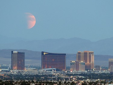 An eclipsed supermoon rises behind the Las Vegas Strip on Sept. 27, 2015 in Las Vegas, Nevada.