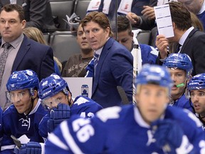 Toronto Maple Leafs head coach Mike Babcock stands behind the bench as his team plays the Montreal Canadiens in both teams' season-opener Oct. 7, 2015, at the Air Canada Centre.