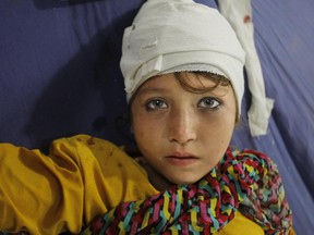 A girl injured from an earthquake is admitted to a local hospital in Peshawar, Pakistan, Oct. 26, 2015.