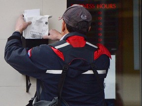 A mail carrier in Ottawa. Everyone should take an inventory of the mail they actually need to receive — and that cannot be obtained by 21st-century methods; online or by email, one letter-writer says.