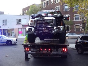 A truck in which Canadiens player Zack Kassian was a passenger is towed away after crashing at the corner of Clanranald Ave. and Côte-St-Luc Rd. in Montreal on Sunday, Oct. 4, 2015. Kassian suffered minor injuries, the team said.