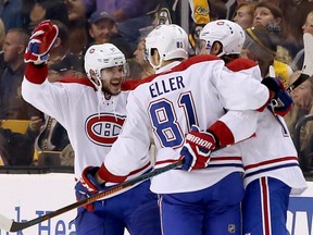 Montreal Canadiens' Alex Galchenyuk, left, and Tom Gilbert, right, congratulate Lars Eller (81) after he scored his second goal of the night, during the second period of an NHL hockey game against the Boston Bruins in Boston, Saturday, Oct. 10, 2015.
