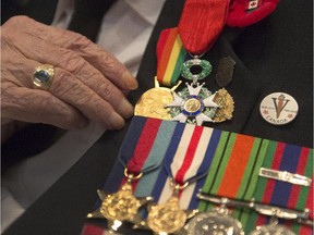 A veteran adjusts his medals in Ste-Anne-de-Bellevue.