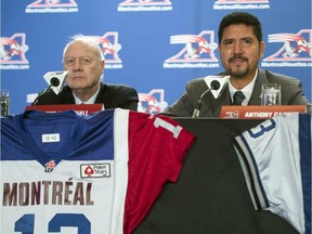 Montreal Alouettes quarterback Anthony Calvillo, right, announces his retirement as team owner Bob Wetenhall looks on at a news conference, Tuesday, Jan. 21, 2014 in Montreal.