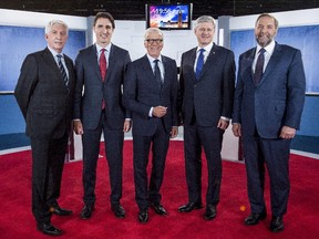 Bloc Québécois leader Gilles Duceppe, left to right, Liberal leader Justin Trudeau, journalist Pierre Bruneau, Conservative leader Stephen Harper and NDP leader Tom Mulcair poses for photos before the start of a French-language debate broadcast by Quebec's TVA network in Montreal on Friday, Oct. 2, 2015.