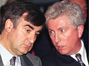 Premier Lucien Bouchard listens to Bloc Québécois leader Gilles Duceppe at a Bloc fundraising event in October 1996.