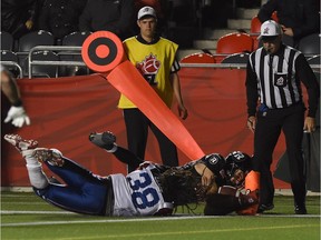 Ottawa Redblacks' Brad Sinopoli scores a touchdown as Montreal Alouettes' Domonique Ellis during third quarter CFL action in Ottawa on Thursday, Oct 1, 2015.