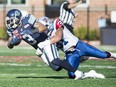Argonauts' Brandon Whitaker is tackled by Alouettes' Winston Venable during second half in Montreal, Monday, October 12, 2015.