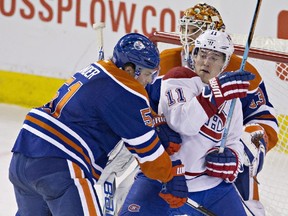 Canadiens' Brendan Gallagher (11) and Oilers' Anton Lander battle in front of goalie Cam Talbot during second period action in Edmonton Thursday night.